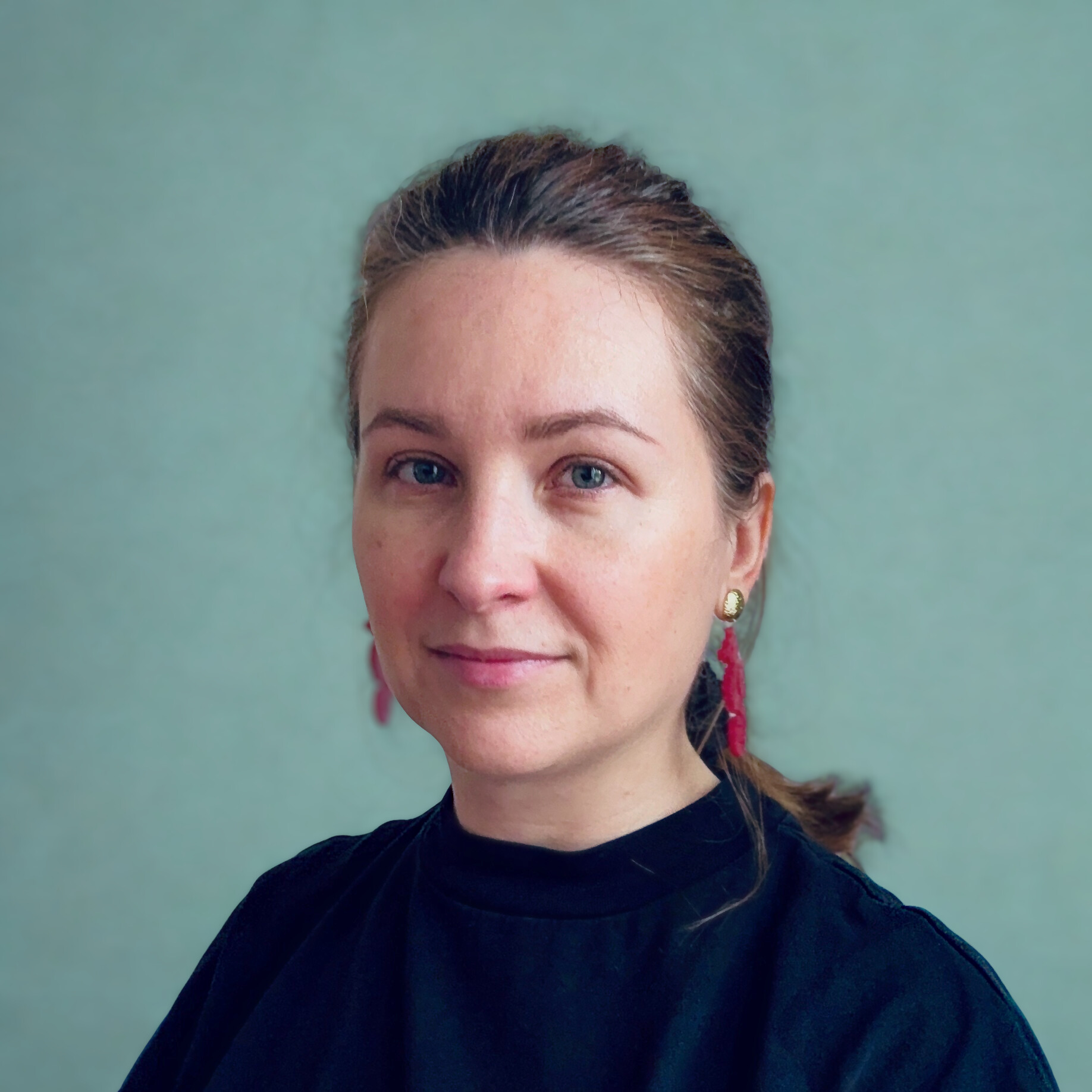 Kata Spychala, headshot against a pale green wall