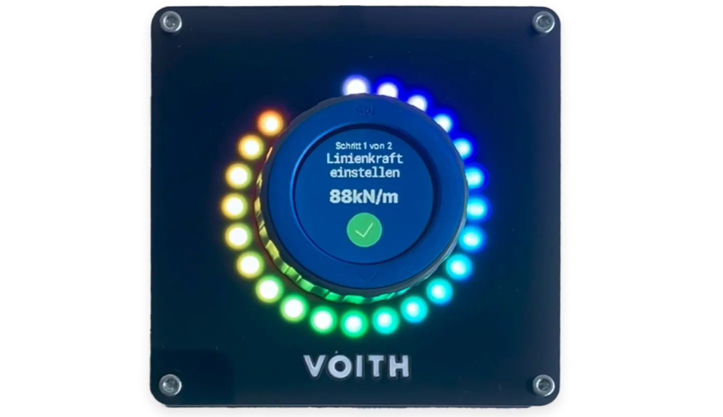 The Smart Button prototype: a rotary control with a small circular display and a ring of lights, mounted on a dark faceplate carrying the Voith name.